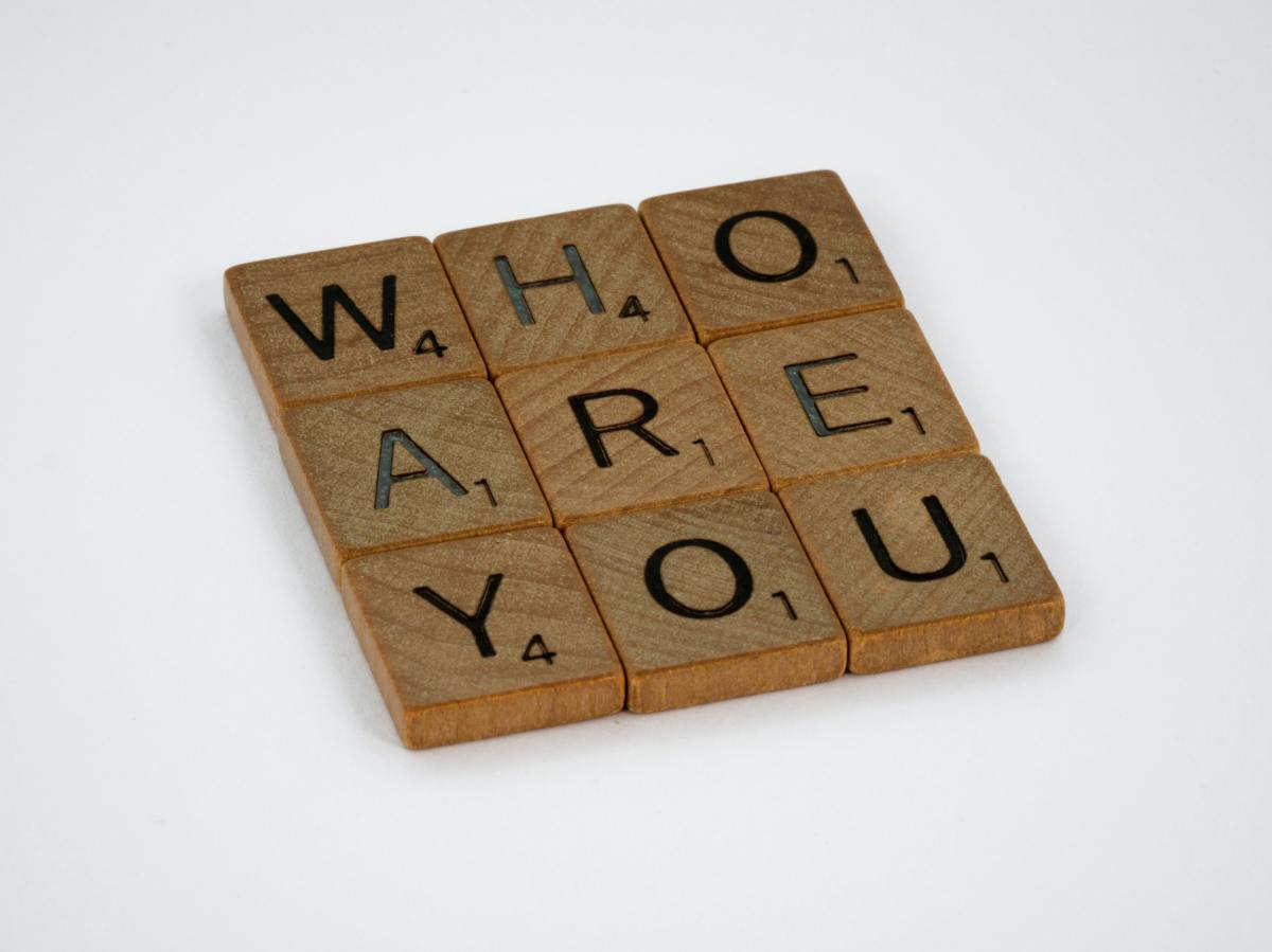 Scrabble tiles spelling out "Who are you"