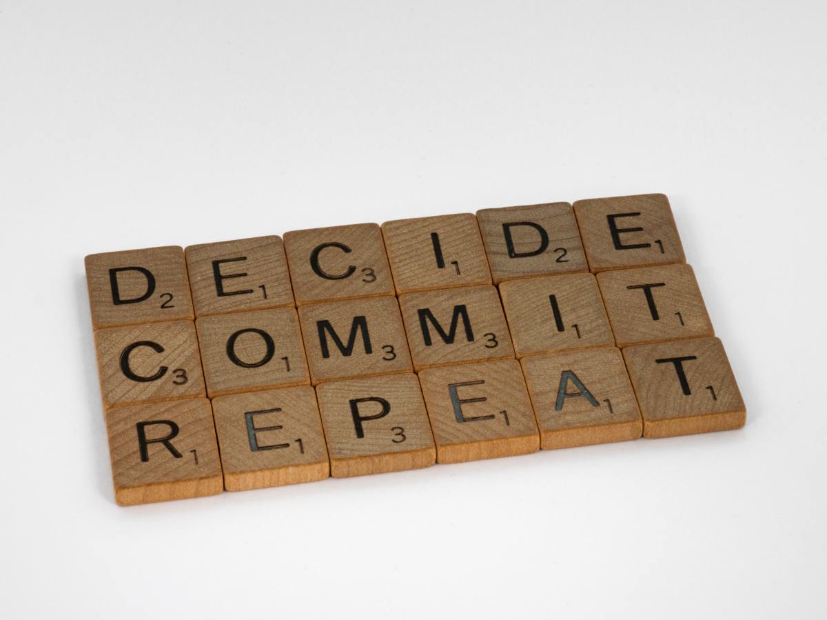 Scrabble tiles showing the words Decide, Commit, Repeat