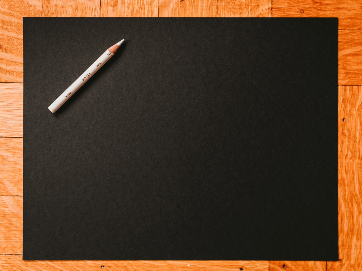 Blank piece of black paper with white pencil