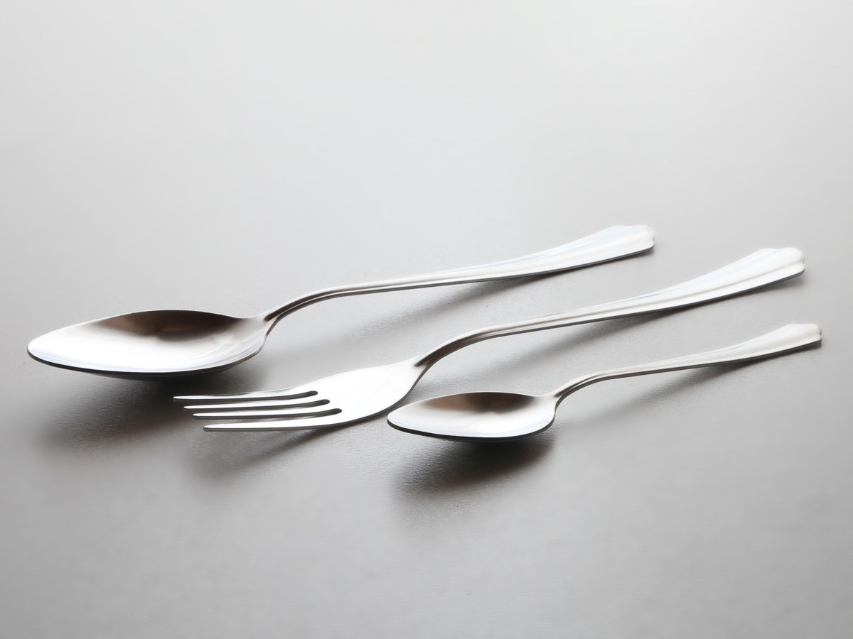 Two metal spoons either side of a fork